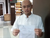 Amir Basuki menunjukkan laporan polisi yang telah dilimpahkan ke Polsek Makassar, Jakarta Timur - foto: Istimewa