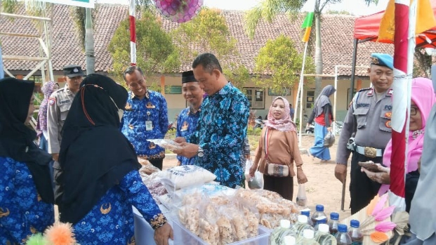 Kepala Kepala Dinas Pendidikan dan Kebudayaan Kabupaten Purworejo, Wasit Diono, S.Sos., didampingi Kepala SMPN 13 Purworejo Achmad Yulianto, S.Pd., saat meninjau stand peserta bazar - foto: Koranjuri.com